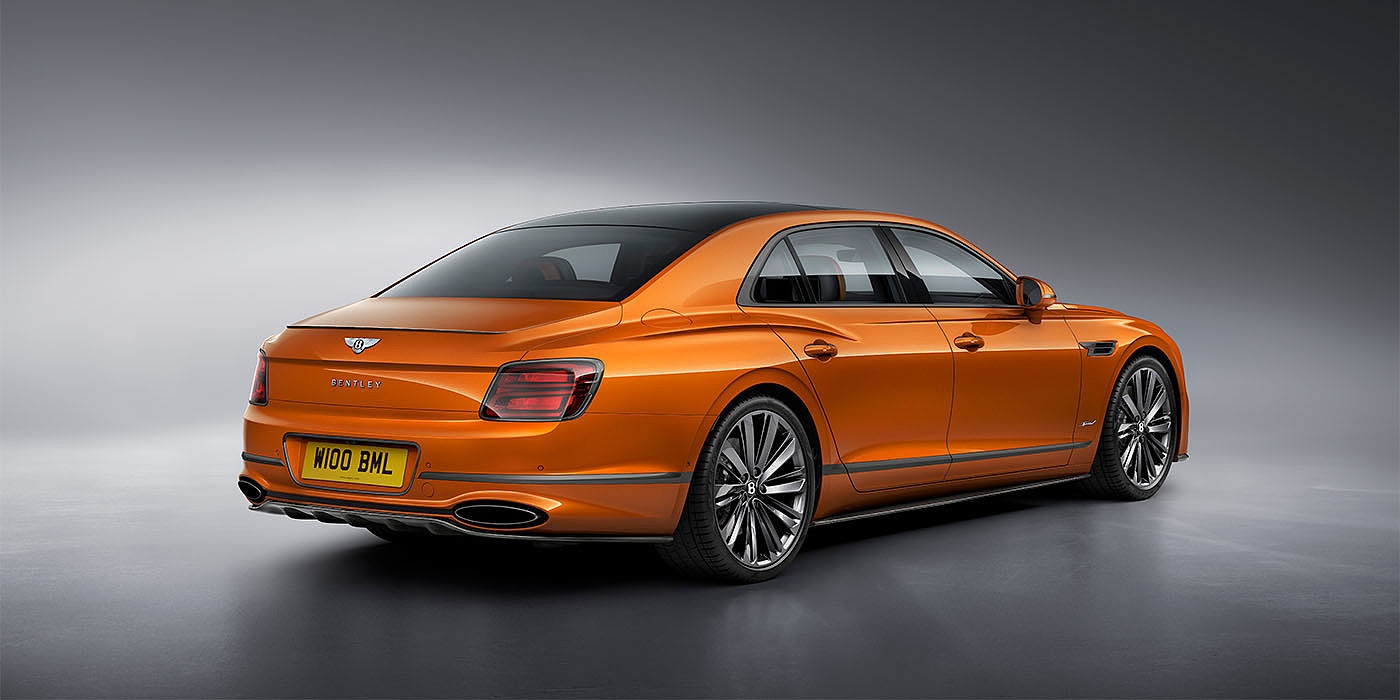 Bentley Gold Coast (Australia) Bentley Flying Spur Speed in Orange Flame colour rear view, featuring Bentley insignia and enhanced exhaust muffler.