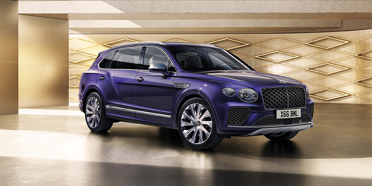 Bentley Gold Coast (Australia) Bentley Bentayga Extended Wheelbase Mulliner SUV front three quarter in Tanzanite Purple paint with a gold patterned background