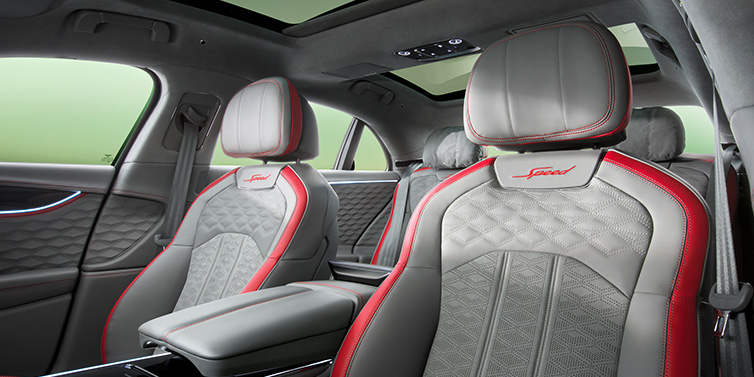 Bentley Gold Coast (Australia) Bentley Flying Spur Speed sedan interior showing front and rear seats in Hotspur red and Gravity Grey hides, with Speed seat emblems