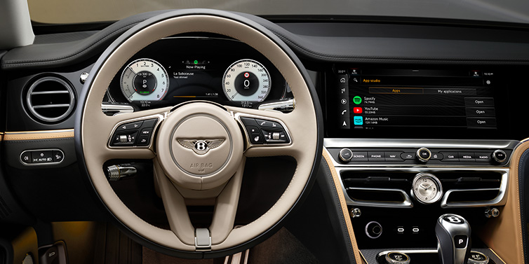 Bentley Gold Coast (Australia) Bentley Flying Spur Mulliner sedan front interior detail of steering wheel and driver screens surrounded by Linen and Beluga black hides